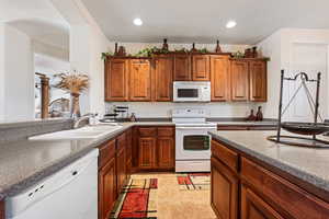 Kitchen featuring white appliances and sink