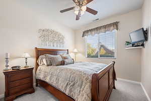 Bedroom featuring ceiling fan and light carpet