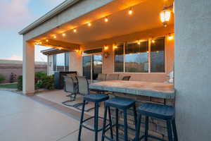 View of patio with outdoor dry bar and fence