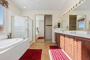 Bathroom with vanity, separate shower and tub, and tile patterned flooring