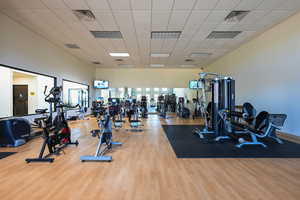 Exercise room featuring light wood-type flooring