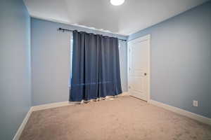 Unfurnished room with carpet floors