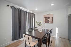 Dining area with light hardwood / wood-style floors