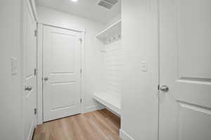 Mudroom with light hardwood / wood-style floors