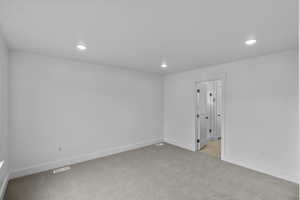 Unfurnished room with light colored carpet