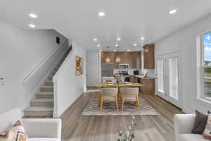 Dining space with sink and light wood-type flooring