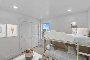 Bedroom featuring carpet floors and a closet