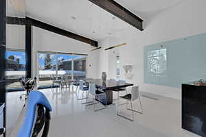 Dining room featuring beamed ceiling and a towering ceiling