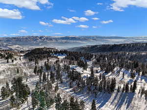 Snowy aerial view featuring a mountain view