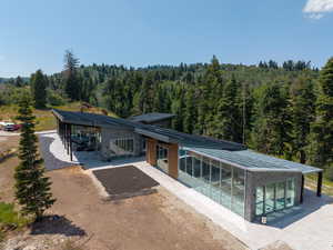 Rear view of house with a forest view