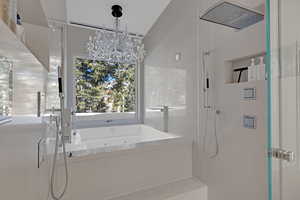 Bathroom with plus walk in shower and a chandelier