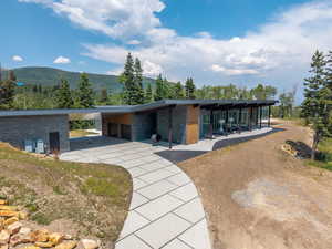 Surrounding community featuring driveway, an attached carport, and a mountain view