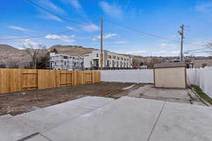 View of patio / terrace with a mountain view and a storage shed