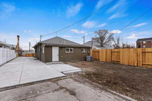 Rear view of house with a patio area and central air condition unit