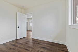 Spare room featuring dark hardwood / wood-style flooring