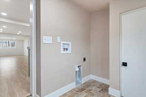 Laundry area with hookup for a washing machine and hookup for an electric dryer