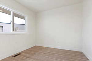 Unfurnished room with light wood-type flooring