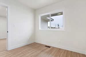 Unfurnished room with light hardwood / wood-style flooring