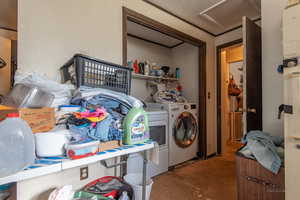 Clothes washing area featuring separate washer and dryer