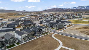 Aerial view of front of home, walking path, view of community park, Park City Mountain Resort and Deer Valley Resort in the background