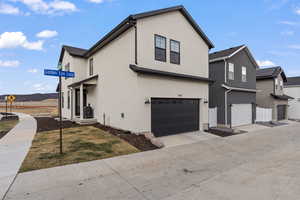 Alleyway view of side porch and 2 car garage