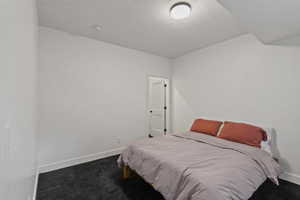 Bedroom with carpet flooring and a textured ceiling