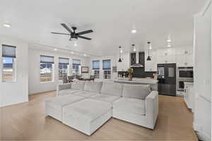 View from back door to spacious living room, dining area and kitchen