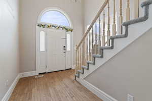 Entrance foyer with light hardwood / wood-style flooring