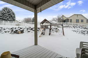 Snow covered deck with a playground