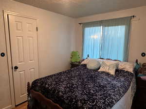 Bedroom #1 featuring a textured ceiling