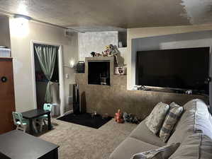 Family Room or Bedroom #3 featuring vaulted ceiling, a textured ceiling, and carpet