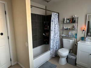 Bathroom #1 with vanity, shower / tub combo, tile patterned floors, and toilet