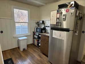 Kitchen featuring dark hardwood / wood-style floors and stainless steel refrigerator