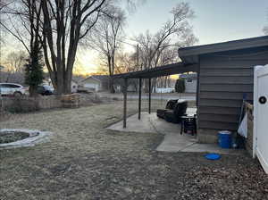 Yard at dusk with a patio area