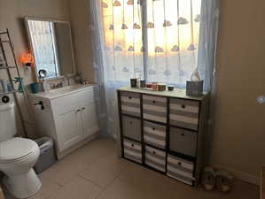 Bathroom #1 featuring tile patterned flooring, vanity, and toilet