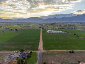 Aerial view at dusk featuring a mountain view and a rural view