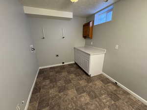 Laundry area with washer hookup and a textured ceiling