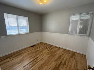 Unfurnished room featuring hardwood / wood-style flooring