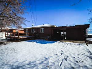 Snow covered property with a deck