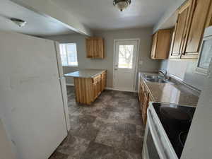 Kitchen featuring sink and white appliances