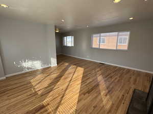 Spare room with hardwood / wood-style floors