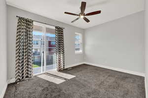 Spare room featuring carpet floors and ceiling fan