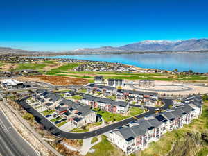 Birds eye view of property with a water and mountain view