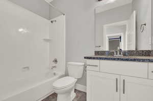 Full bathroom featuring vanity, toilet, and shower / bath combination