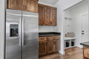 Kitchen featuring light hardwood / wood-style flooring and stainless steel fridge