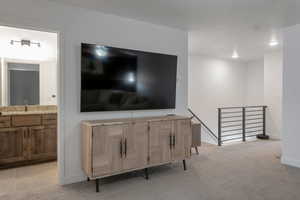 Living room featuring sink and light carpet