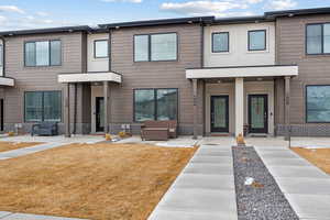 View of property with a front lawn and an outdoor hangout area