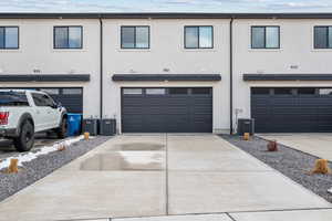 Exterior space with central AC unit and a garage