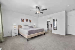 Carpeted bedroom with ceiling fan