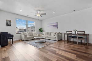 Living room featuring hardwood / wood-style flooring and ceiling fan